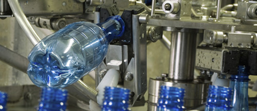 Plastic water bottles on conveyor or water bottling machine industry